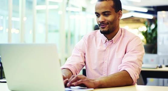 Male student working on his laptop