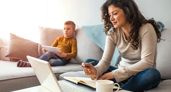 Woman working on homework on a laptop